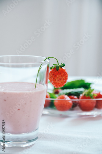 Wallpaper Mural Strawberry milkshake in glass garnished with fresh strawberries on white background Torontodigital.ca