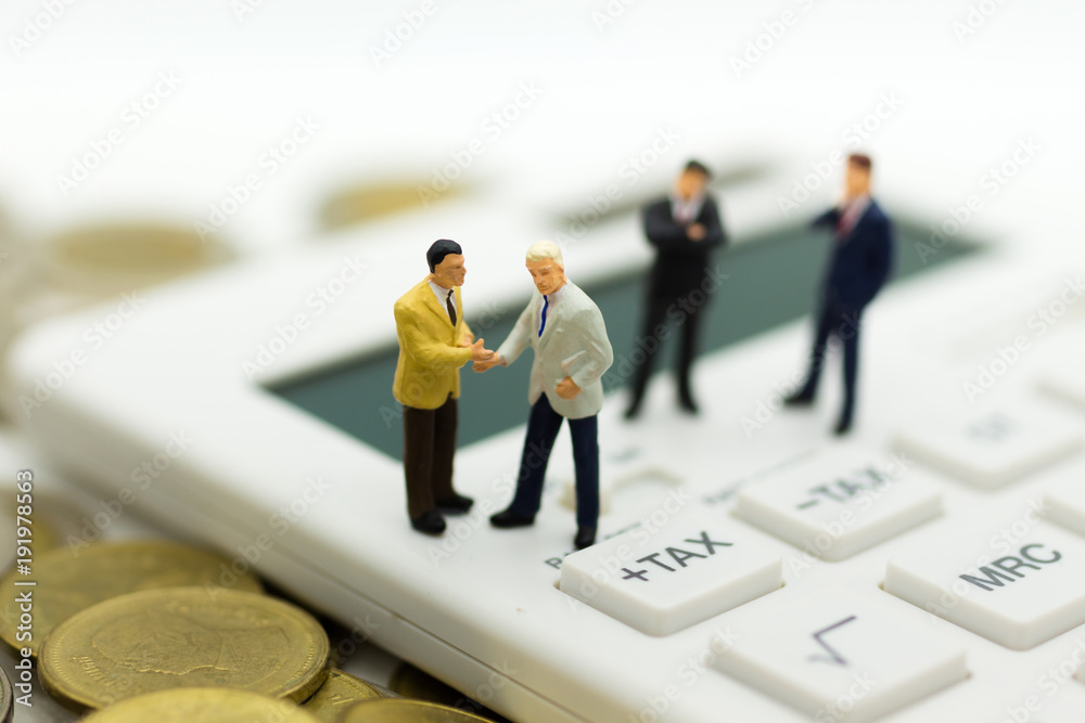 Miniature people: Businessman stand on calculator, calculation tax monthly/yearly. Image use for Tax calculation every year for everyone. Miniature people: Businessman stand on calculator, calculation tax monthly/yearly. Image use for Tax calculation every year for everyone.