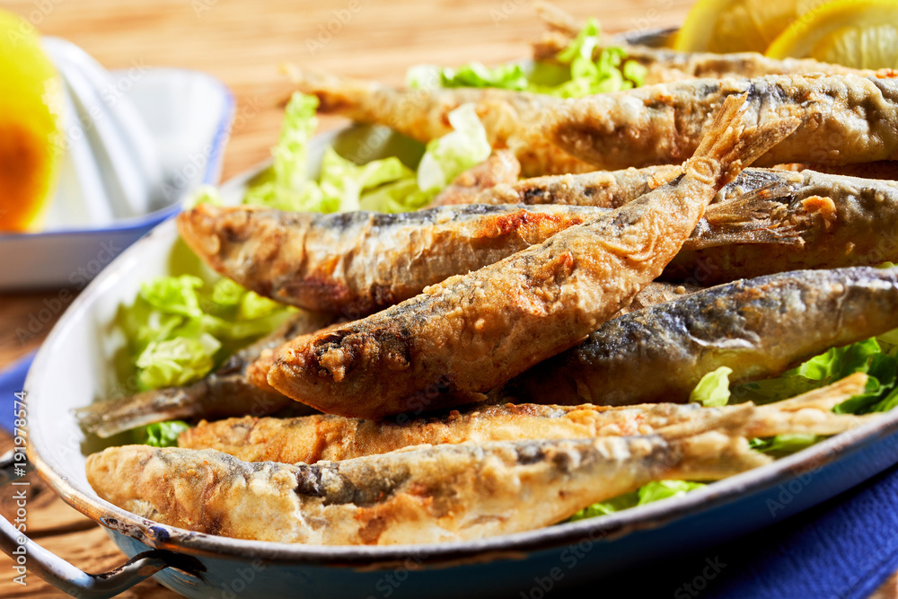 Plate of fried sardines, pilchards or anchovies