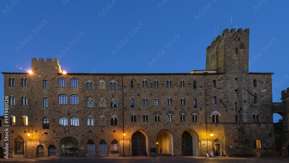 Pretorio Palace and Porcellino Tower, Priori Square in a quiet moment of the evening with the blue light, Volterra, Pisa, Tuscany, Italy