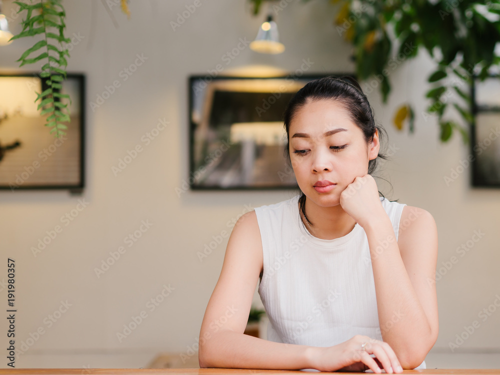 Woman with bored expression is waiting for some one or thinking of something. Woman with bored expression is waiting for some one or thinking of something.