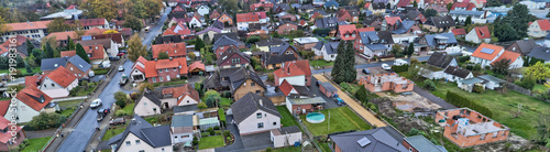 Fotografie, Obraz Aerial view of a suburb in Germany with detached houses, streets and gardens