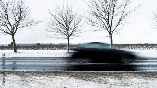 Car on road in winter in Denmark