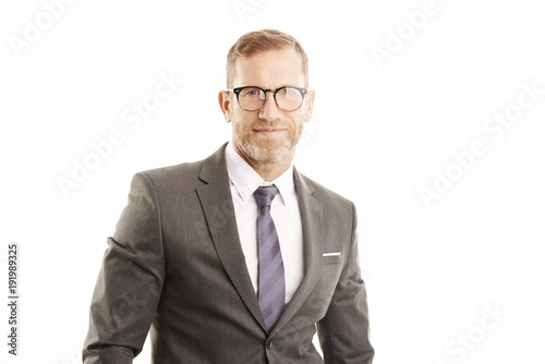 Smiling businessman portrait. Successful senior manager business man wearing suit while standing against at isolated white background. 