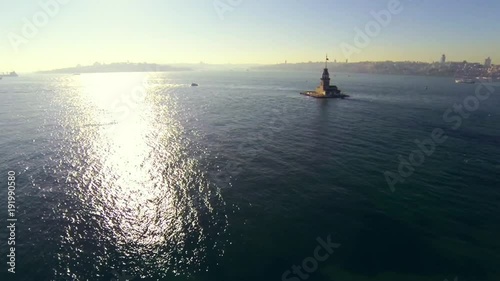 High angle view at Istanbul, Turkey. In the distance historical light house, old city and European side. Fly over Bosphorus Sea towards Maidens Tower at sunset photo