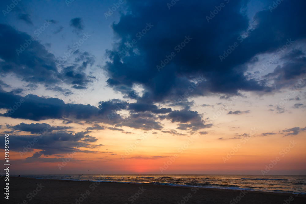 Beautiful sunset on an empty sandy beach.