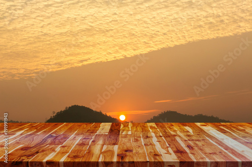 wooden floor and sunrise sky background.