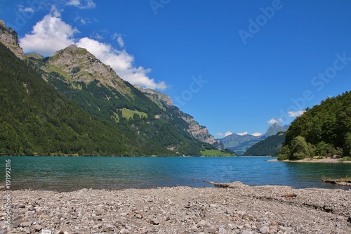 Beautiful place for swimming at lake Klontalersee, Switzerland. Summer scene in the Swiss Alps.