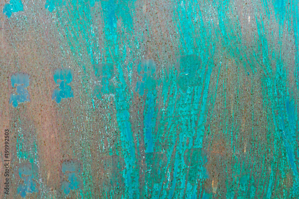 Textured metal surface carelessly colored blue paint and faded in the sun in pale gray with rusty specks.