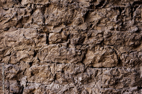 Textured background of a wall of medieval stone masonry. The wall is sloppy built of mountain stones. Medieval style © yanik88