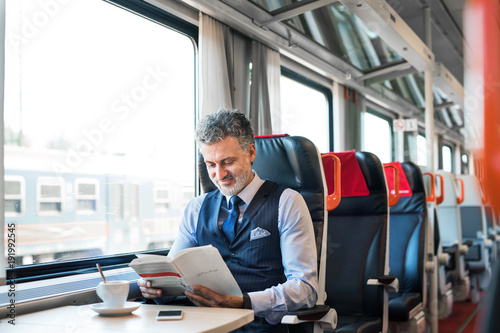 Mature businessman travelling by train. photo