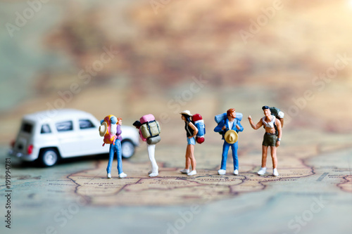 Miniature backpacker on map with car, Concept of Travel around the world and the adventure.