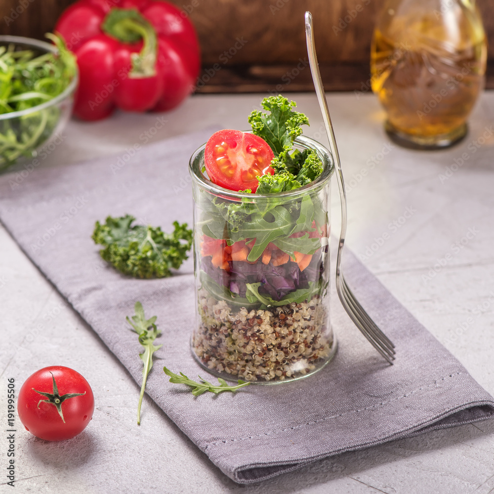 Quinoa salad in glass jar with arugula and kale, healthy snack, diet and vegan food concept Quinoa salad in glass jar with arugula and kale, healthy snack, diet and vegan food concept