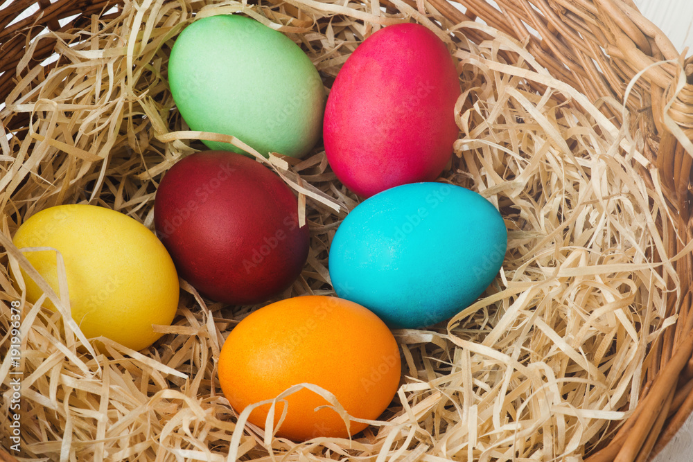Colorful Easter eggs in basket Colorful Easter eggs in basket