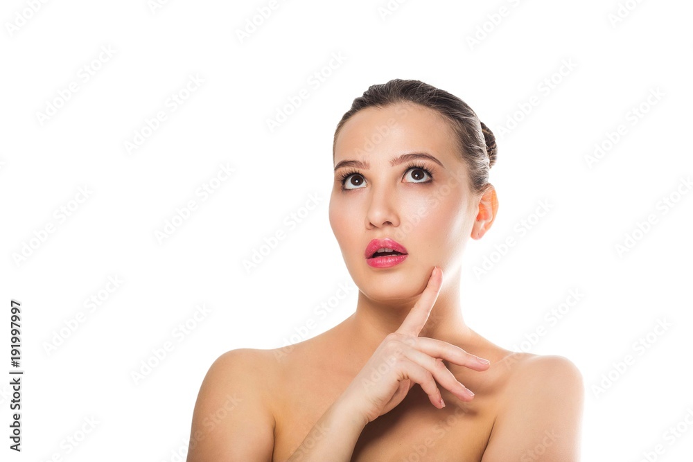 Beautiful surprised woman bare shoulders, looking to side. Expressive facial expressions. Cosmetology, Spa Beautiful surprised woman bare shoulders, looking to side. Expressive facial expressions. Cosmetology, Spa