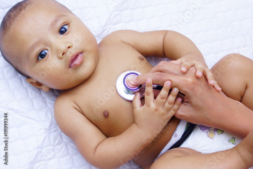 Doctor Using A Stethoscope To Listen To Baby's Chest , Baby Health Concept