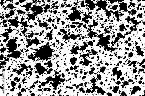 Black splashes shapes on white paper backdrop for graphic design.