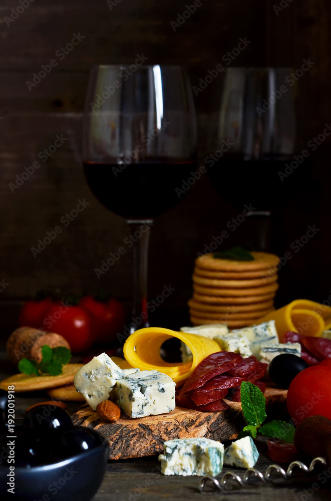 Snacks for wine: blue cheese, olives, salami. Delicacies. Rustic food background.