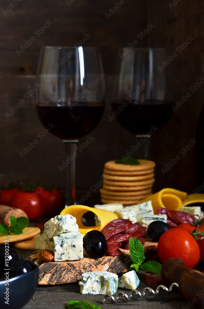 Snacks for wine: blue cheese, olives, salami. Delicacies. Rustic food background.