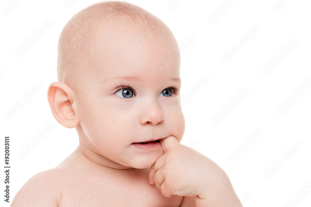 Adorable baby boy with blue eyes sucking on his finger, looking away from camera. Cute teething toddler boy close up portrait isolated on white background. Adorable baby boy with blue eyes sucking on his finger, looking away from camera. Cute teething toddler boy close up portrait isolated on white background.