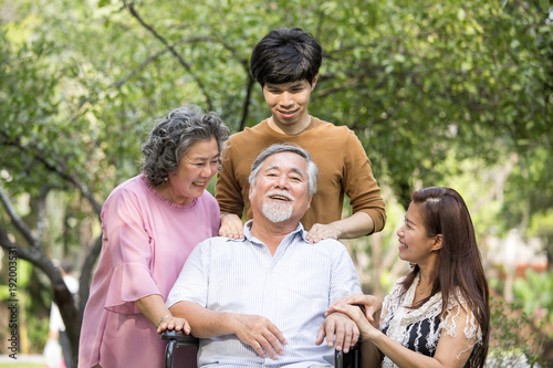 Portrait of Asian Family Relaxing In Park Together. People lifestyle concept.