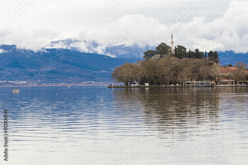 Ioannina lake called "Pamvotis" in a winter cloudy foggy day