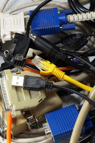 A tangle of various cables and computer plugs