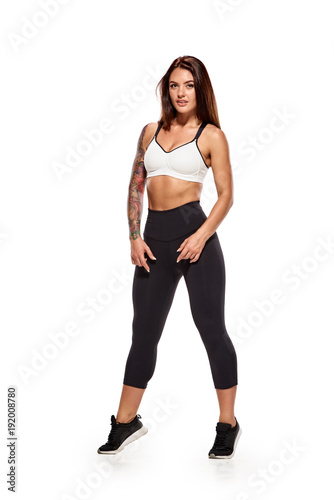 Young fitness trainer. Young athletic healthy woman demonstrating her strong body