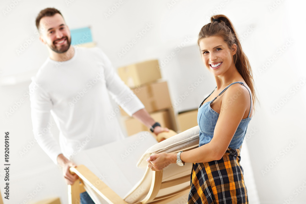 Fototapeta premium Happy adult couple moving out or in to new home