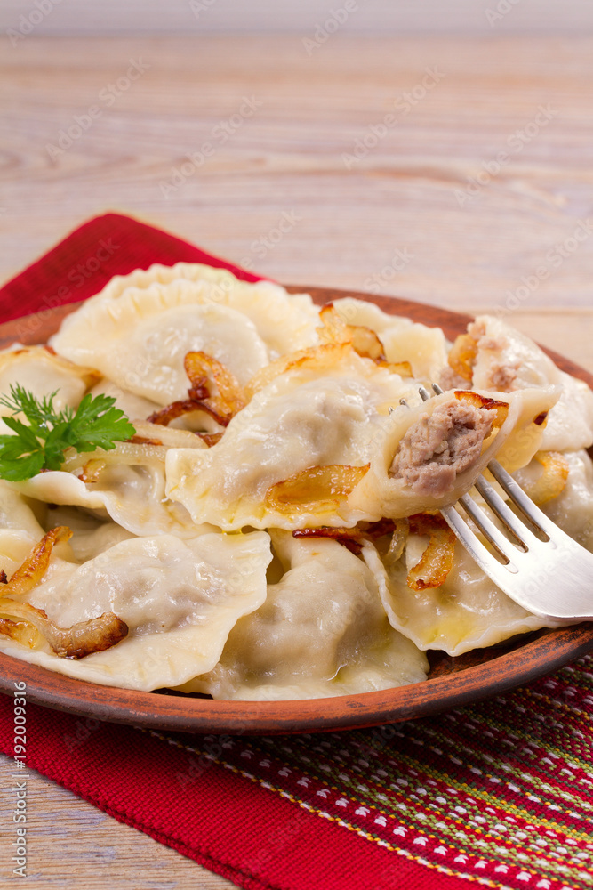 Dumplings, filled with beef meat and served with fried onion. Varenyky, vareniki, pierogi, pyrohy. Dumplings with filling Dumplings, filled with beef meat and served with fried onion. Varenyky, vareniki, pierogi, pyrohy. Dumplings with filling