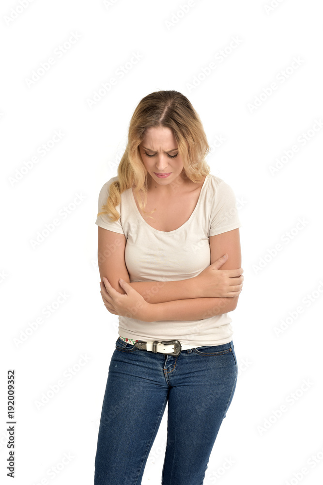 3/4 portrait of blonde girl wearing white shirt, sad expression. isolated on white background. 3/4 portrait of blonde girl wearing white shirt, sad expression. isolated on white background.