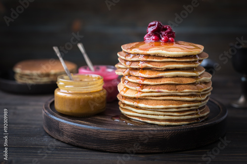 Pancakes with honey, jam and berries