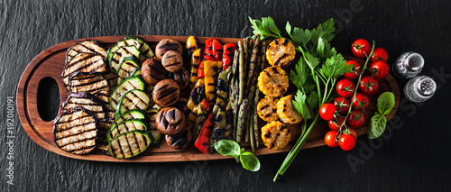 banner . a large wooden tray with a Summer snack, colorful Barbecue Vegetables, cherry tomatoes and greens. summer delicious healthy food for a big company of people or friends