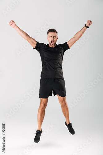 Full length portrait of a cheerful mature sportsman