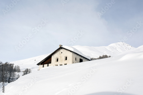 A village house in the snow covered hill in the alps switzerland in winter
