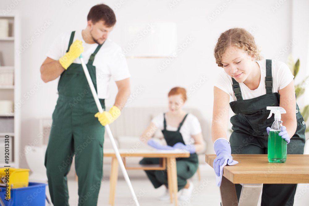 Woman using green cleaning detergent Woman using green cleaning detergent