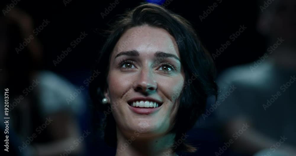 A woman laughing at the cinema A woman laughing at the cinema