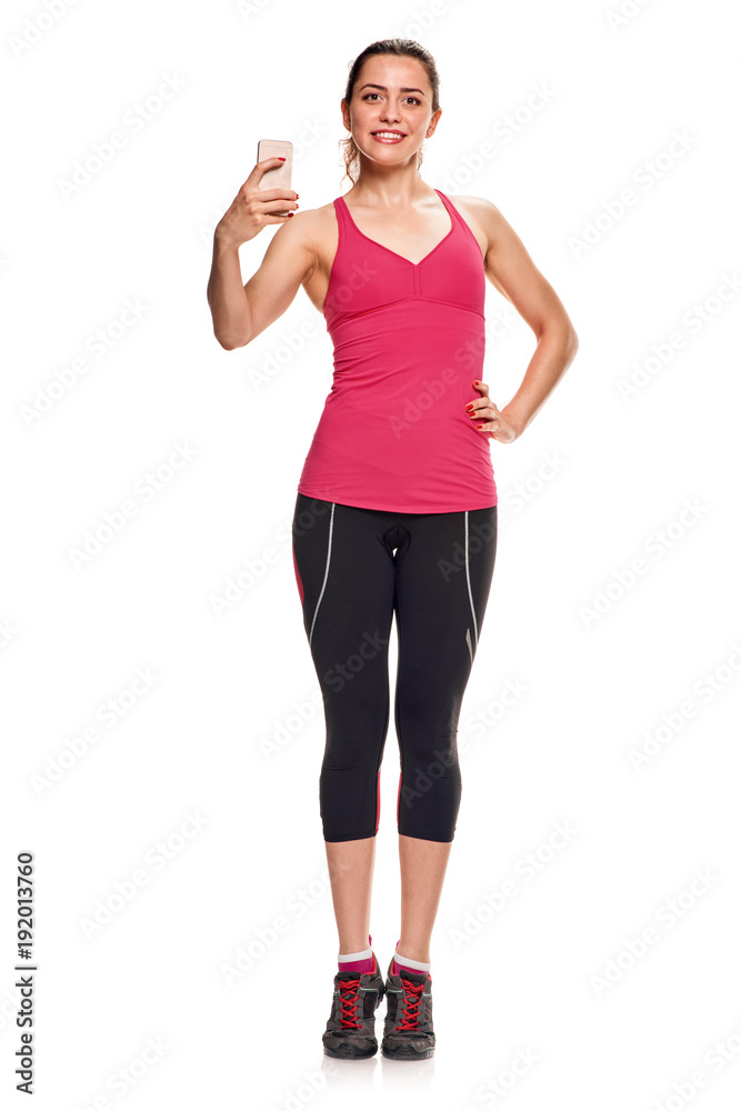Young pretty fit girl in sportswear making selfie. full length Young pretty fit girl in sportswear making selfie. full length