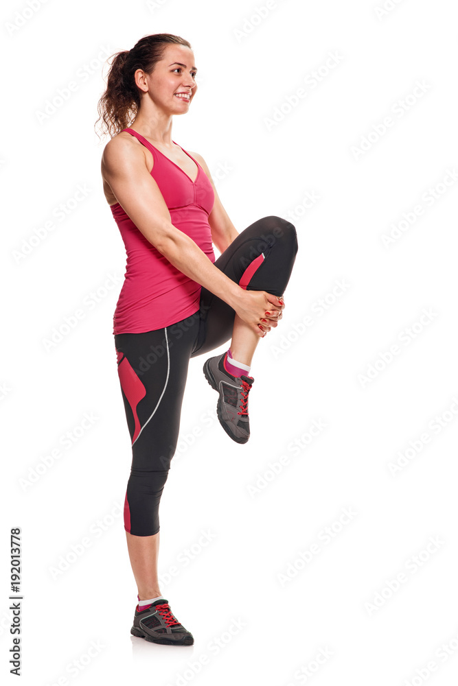 Pretty young slim woman stretching her leg Pretty young slim woman stretching her leg