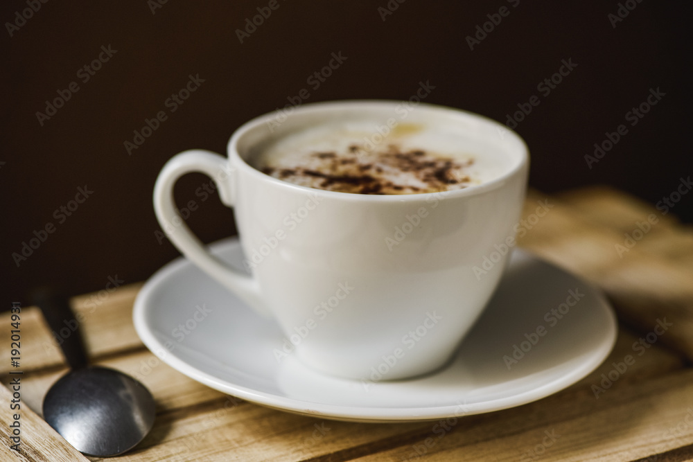 cup of cappuccino on a wooden tray cup of cappuccino on a wooden tray