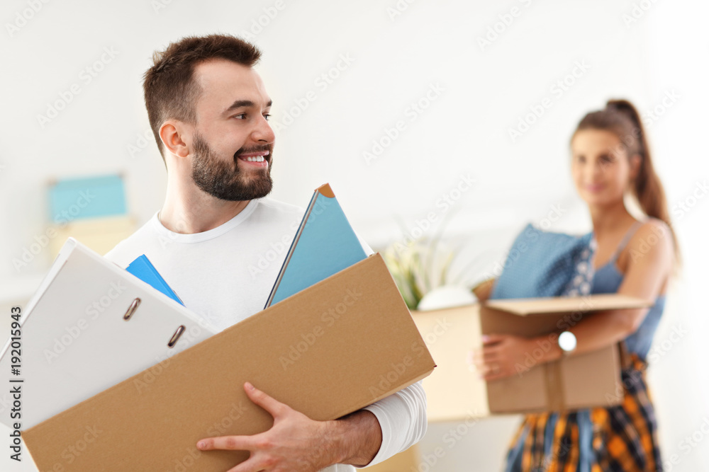 Happy adult couple moving out or in to new home Happy adult couple moving out or in to new home