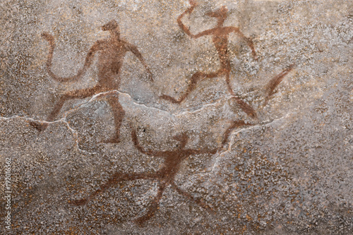 images of ancient people from ocher on the wall of the cave. the science. history. archeology.