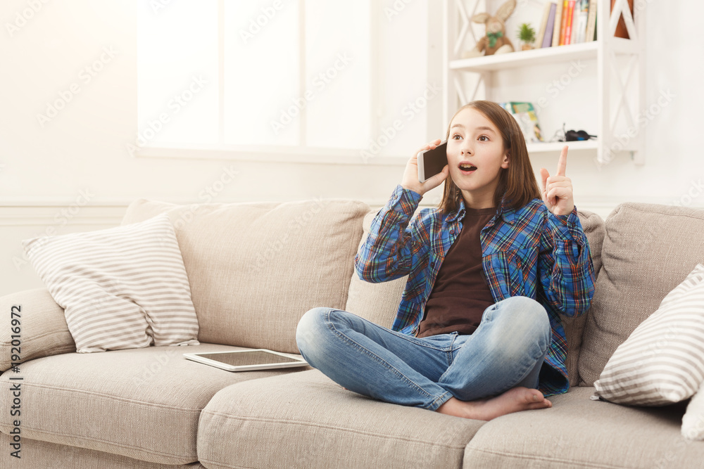 Young girl at home talking on mobile phone Young girl at home talking on mobile phone