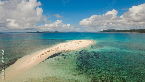 Aerial view of beautiful sand tropical island with white sand beach and tourists. White sand island. Seascape: ocean and beautiful beach paradise. Philippines, Siargao. Travel concept.