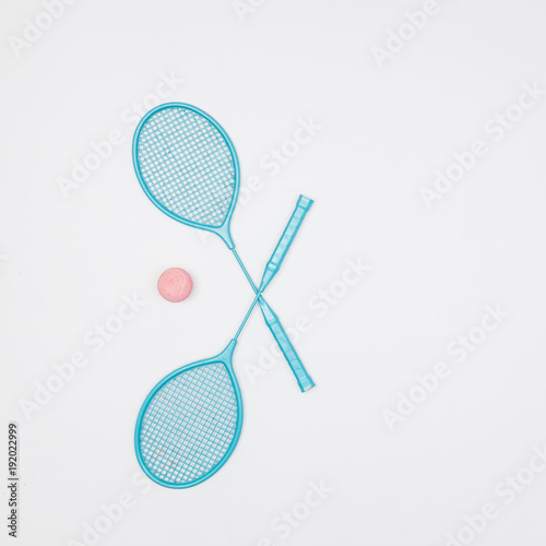 colorful tennis rackets and ball on white background