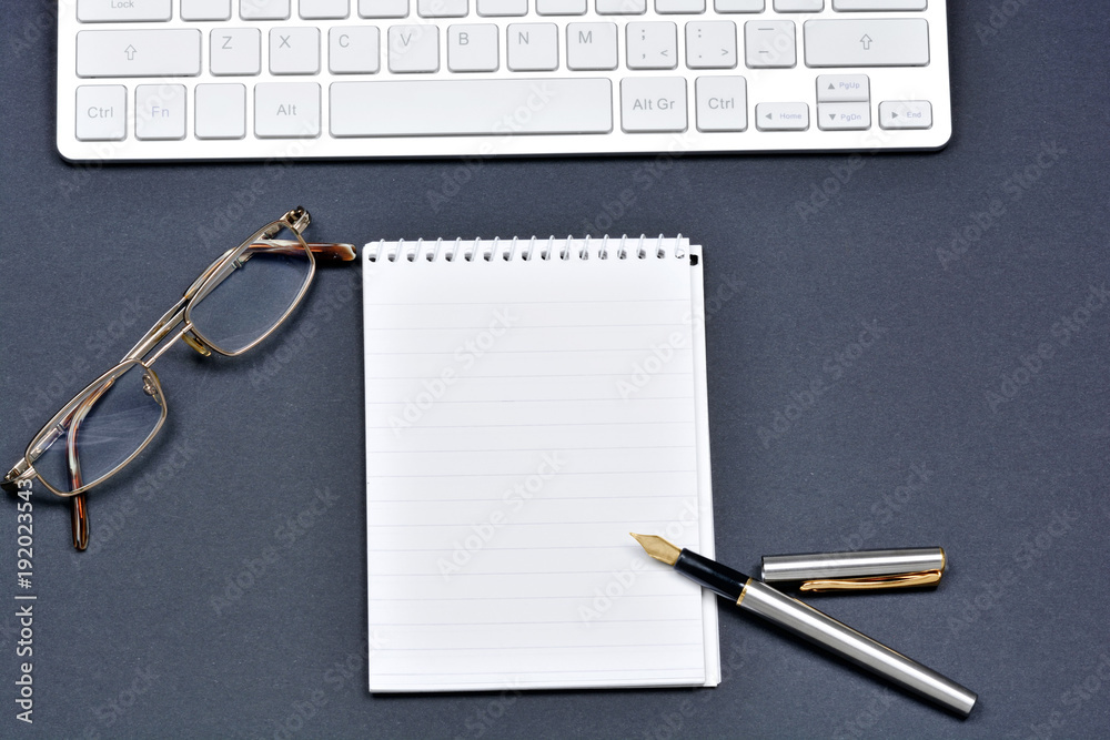 Notepad with fountain pen, eyeglasses and keyboard computer Notepad with fountain pen, eyeglasses and keyboard computer