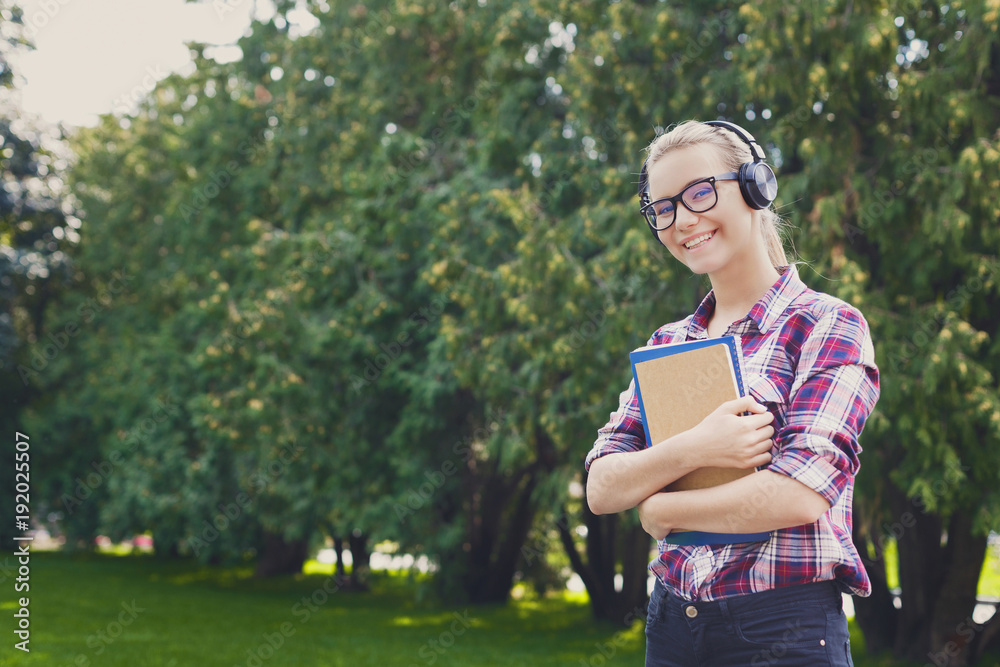 Student girl with books in park outdoors Student girl with books in park outdoors