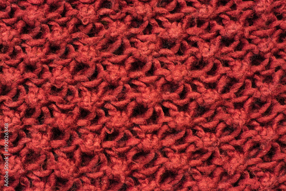 Knitted burgundy pattern close up background Knitted burgundy pattern close up background
