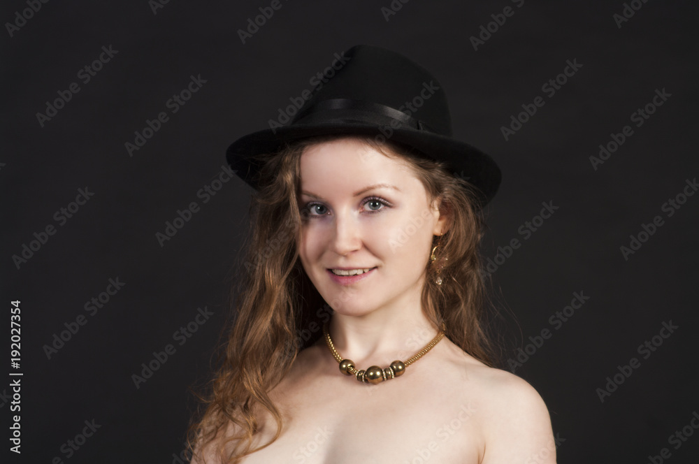 Portrait of a young woman in a hat and gloves. Portrait of a young woman in a hat and gloves.