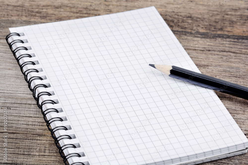 Empty notebook with pencil on table Empty notebook with pencil on table